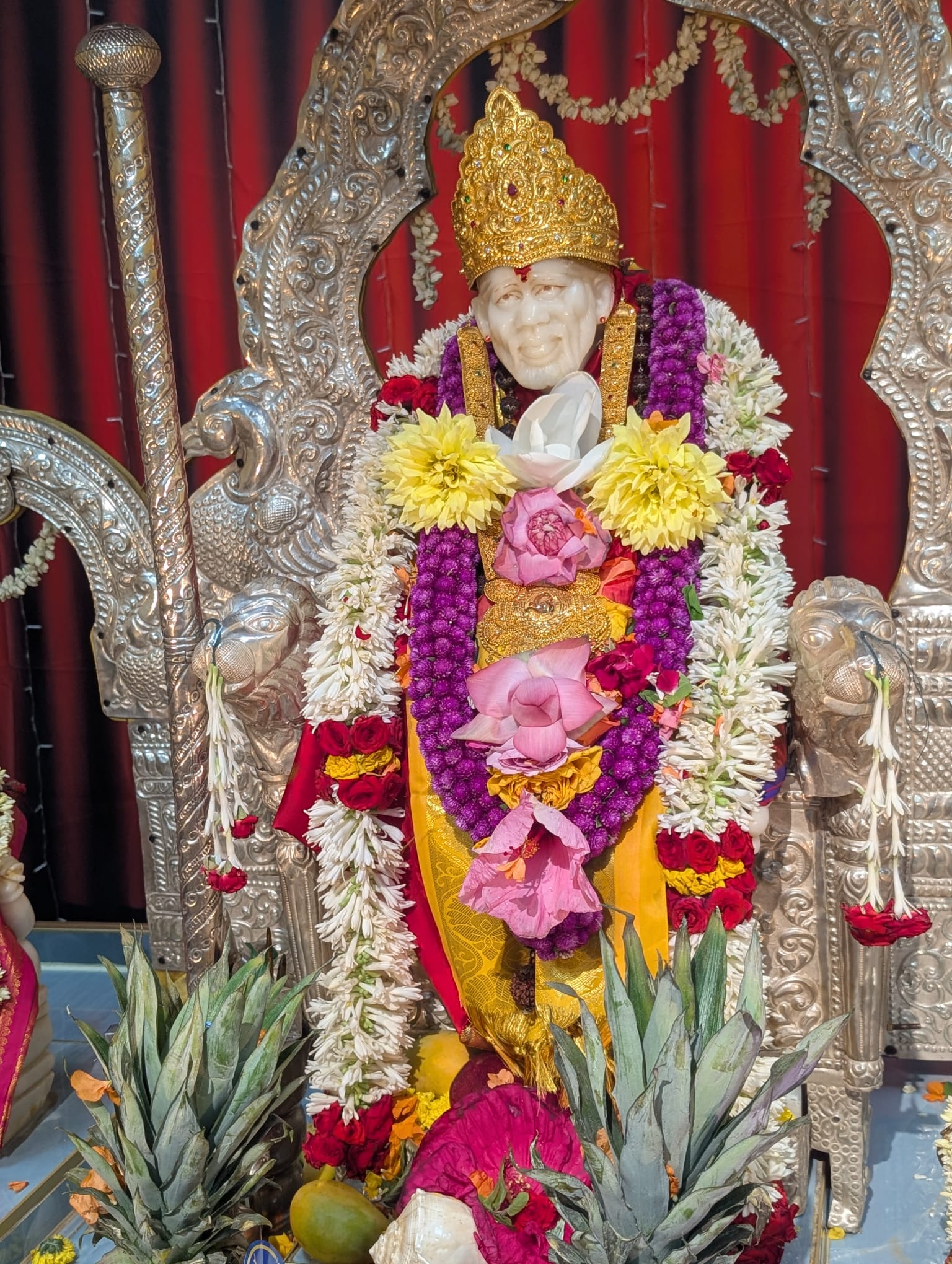 Sai Baba altar decorated with flowers and devotional offerings
