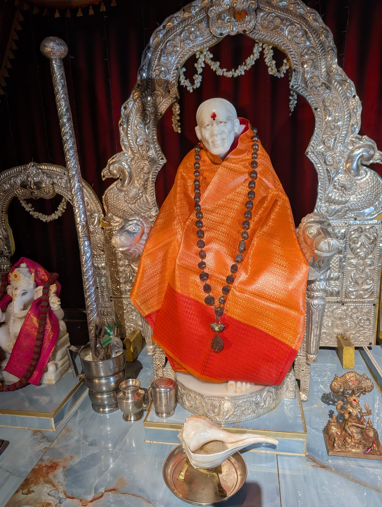 Sai Baba shrine dressed in orange vastram inside the temple